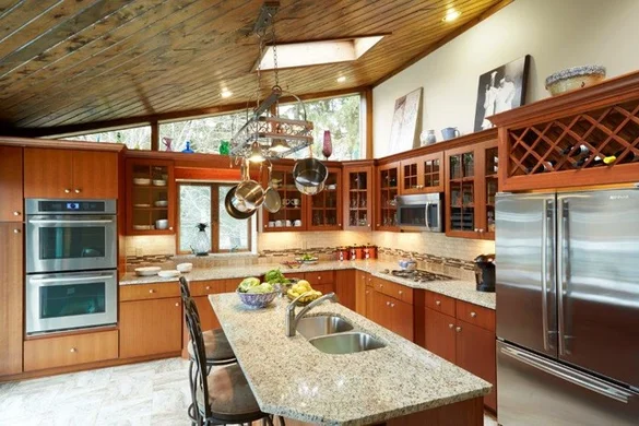 Kitchen with vaulted wood-plank ceiling, cherry cabinets, and built-in wine storage
