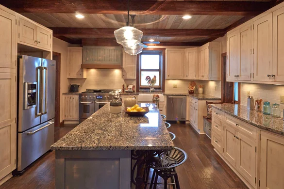 Modern white kitchen with cherry wood accents by Masterpiece Kitchens in The Villages, FL